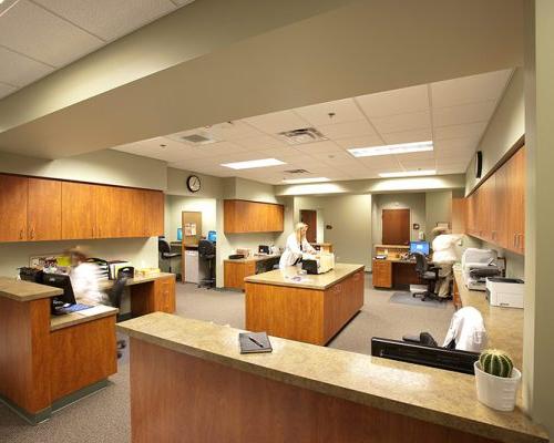 Interior photo of work station. Cabinet and counter space line the room with a work area in the middle.