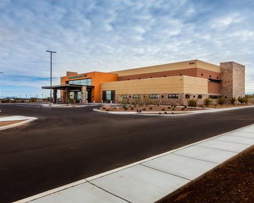 Exterior photo of TMC Rincon Health Campus. Street and parking area are in the foreground of the photo.